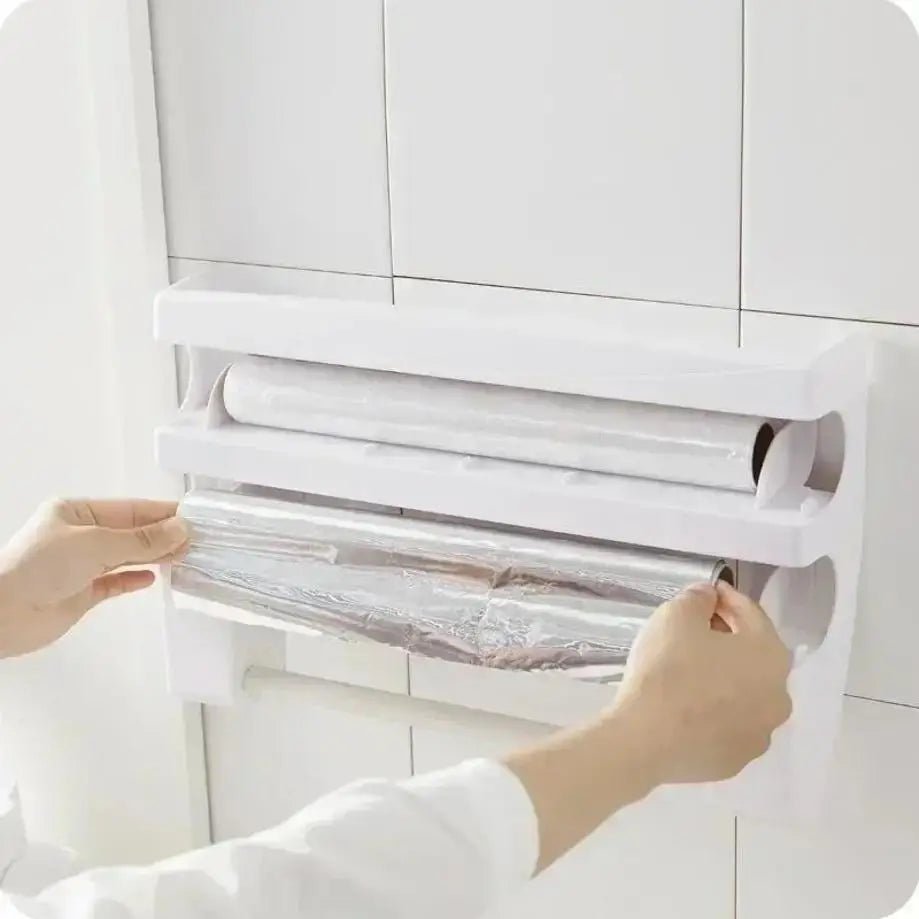 Person using a plastic wrap dispenser with multiple rolls on a white background
