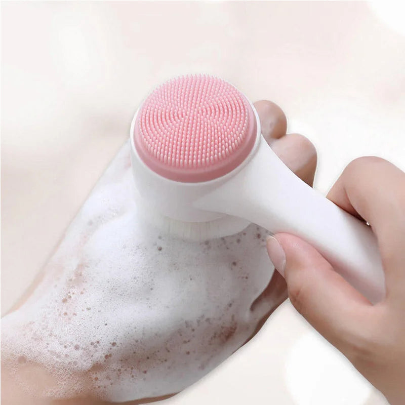 Person using a white and pink facial cleansing brush on a white background