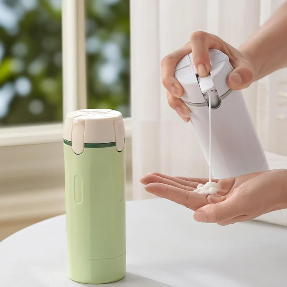 Person using a white bottle to dispense liquid into their hand, with a green container on a surface.