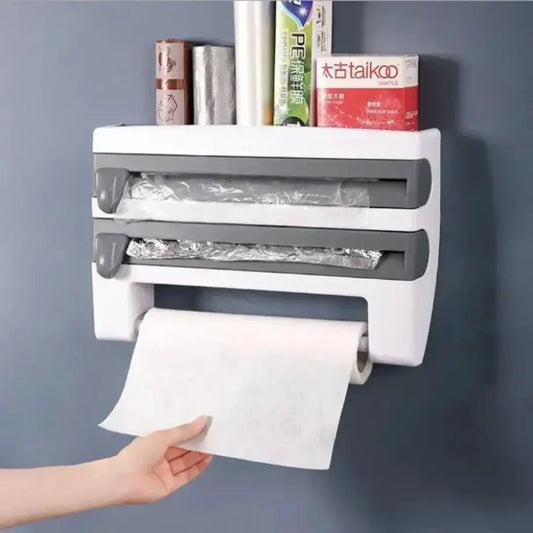 Wall-mounted paper towel holder with a hand pulling out a roll of paper towels against a gray background.